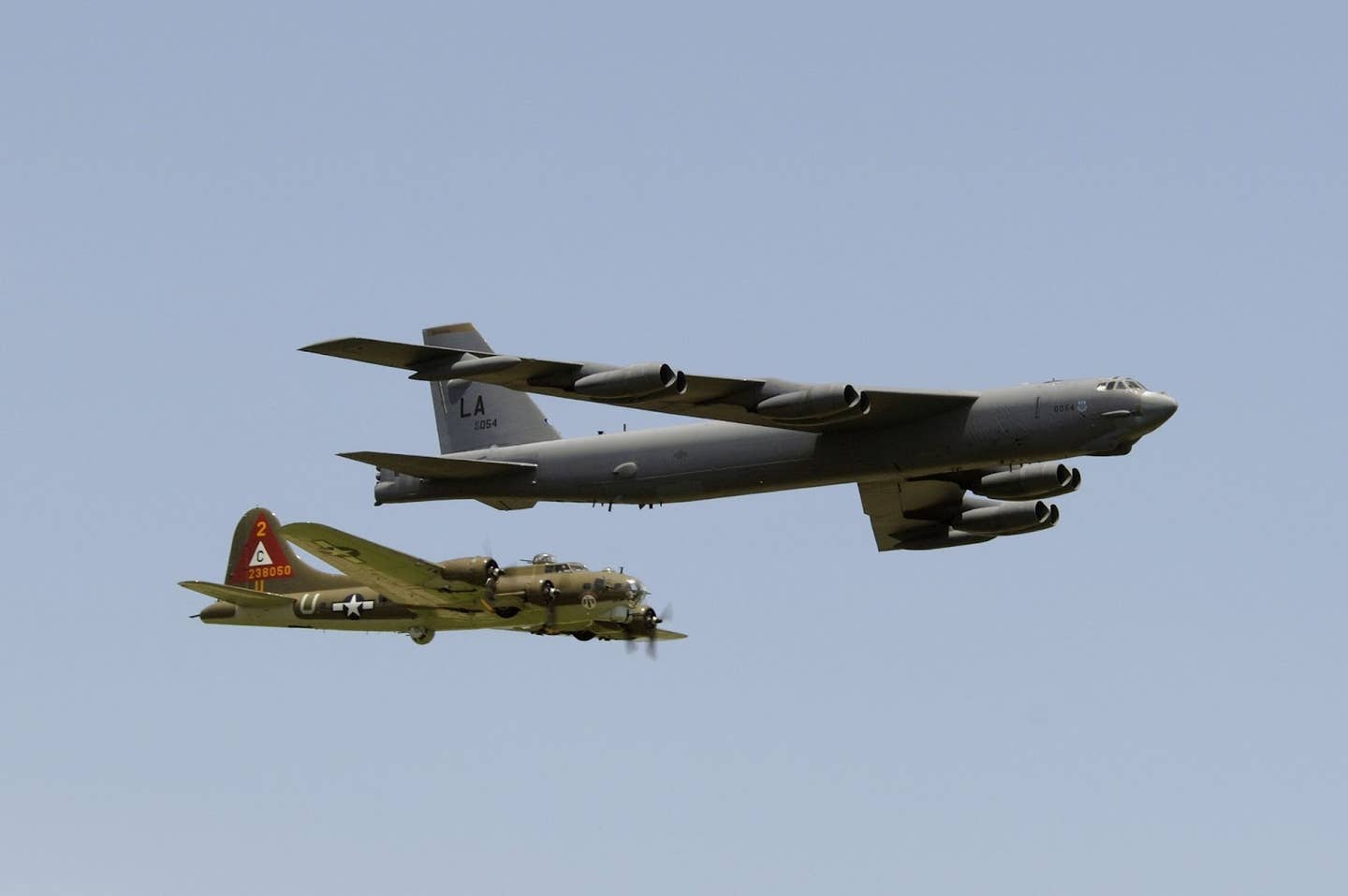 A B-17G Flying Fortress and a B-52H Stratofortress fly in a heritage flight formation.